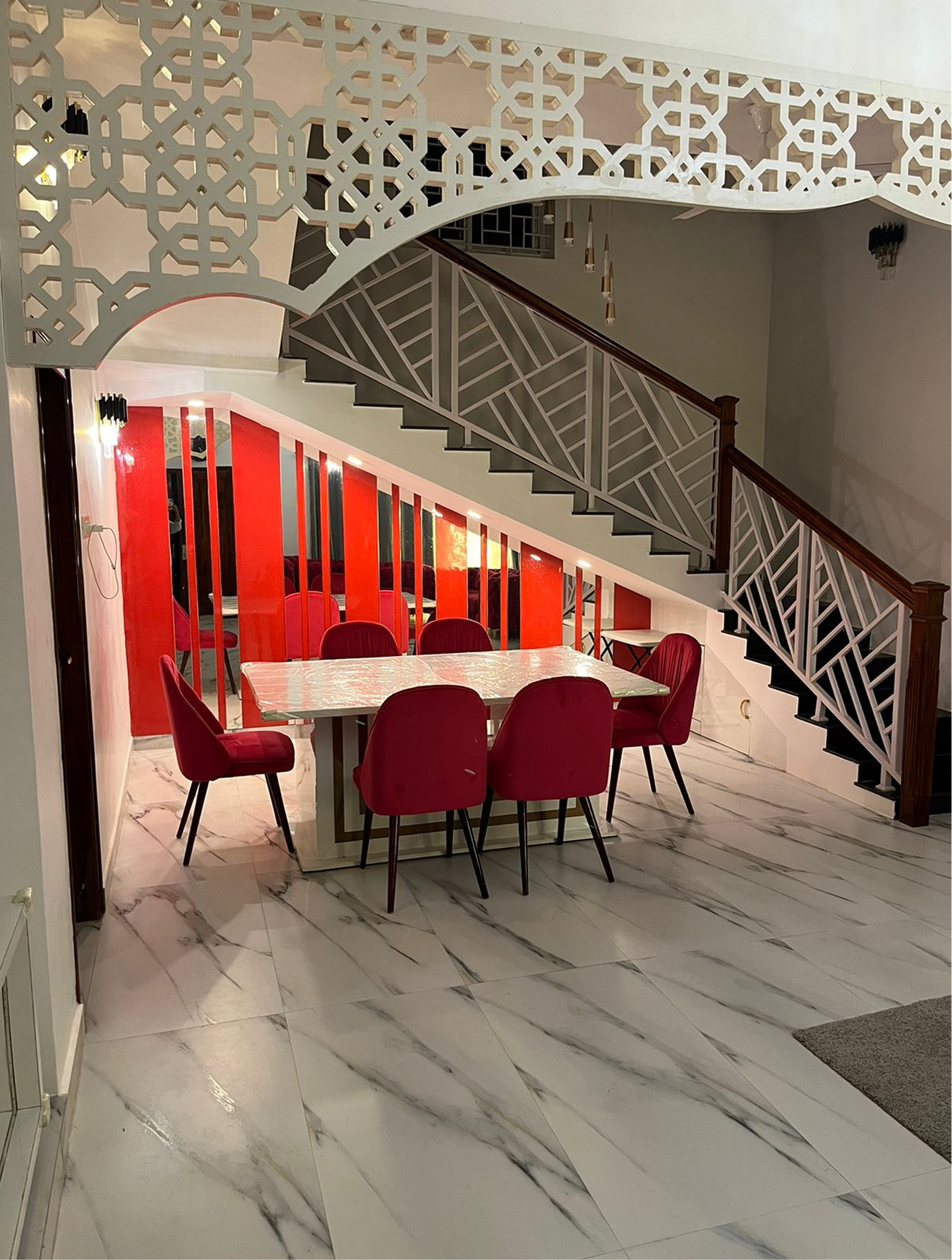 Dining area and architectural staircase at Classy Villa